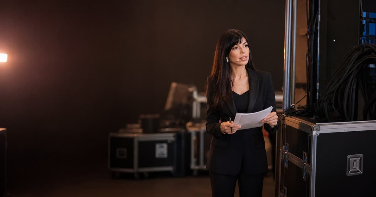 Rima Iskandarani reviewing a run sheet backstage before an event