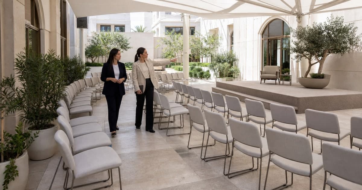 Host and planner checking audience sightlines and access in a covered courtyard venue